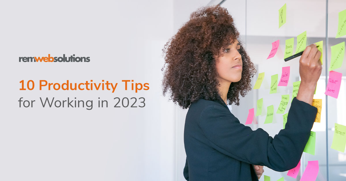 Business woman writing on stickie notes on a whiteboard